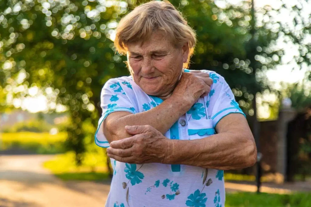Senior woman holding her elbow