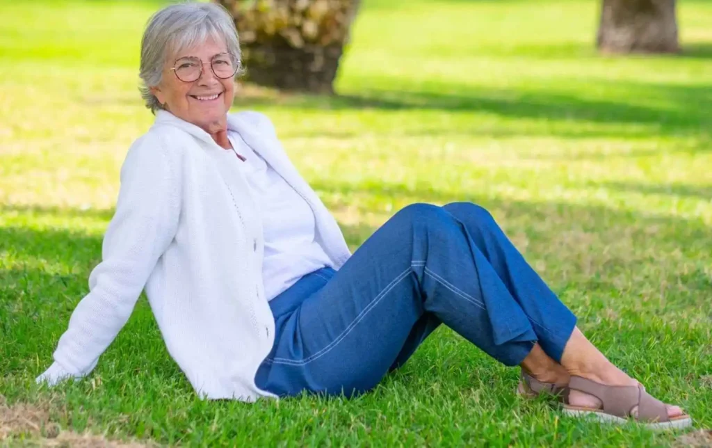 Senior woman sitting in the green yard