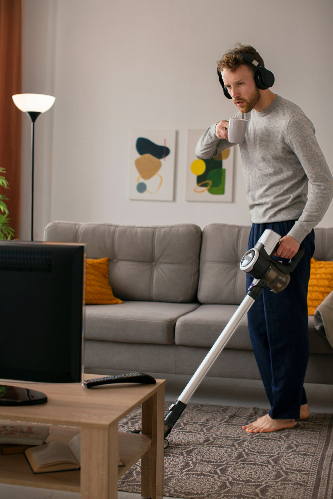 a person vacuuming wearing headphones, Turn up the music and spring clean